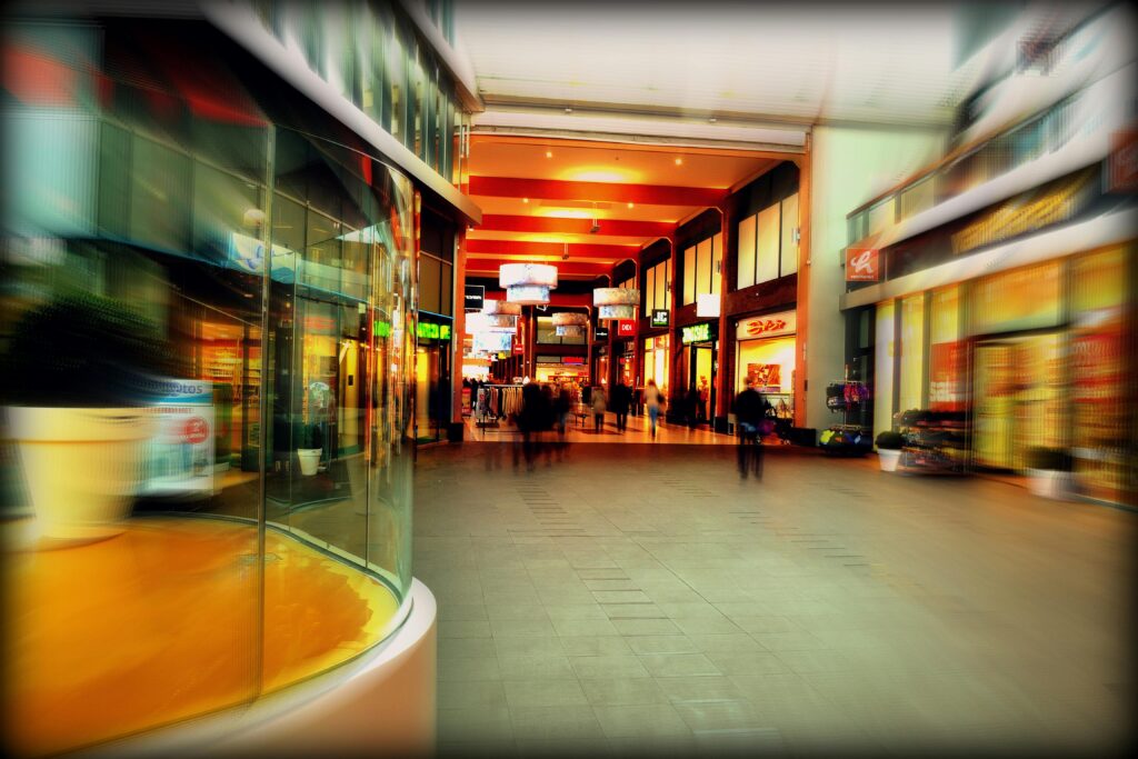 Explore the lively atmosphere of a modern shopping mall in Hoofddorp, Netherlands, captured with vibrant colors and motion blur.